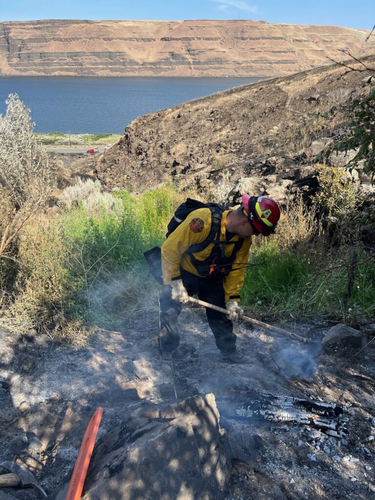 A firefighter actively putting out hot spots on the Hat Rock fire in Umatilla County