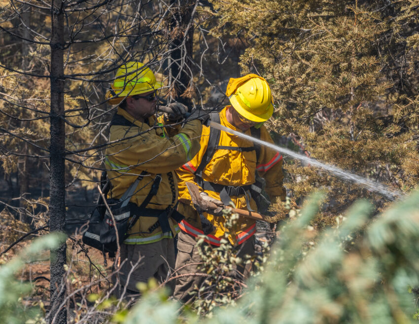 Firefighters spraying water on the Golden Fire in Klamath County