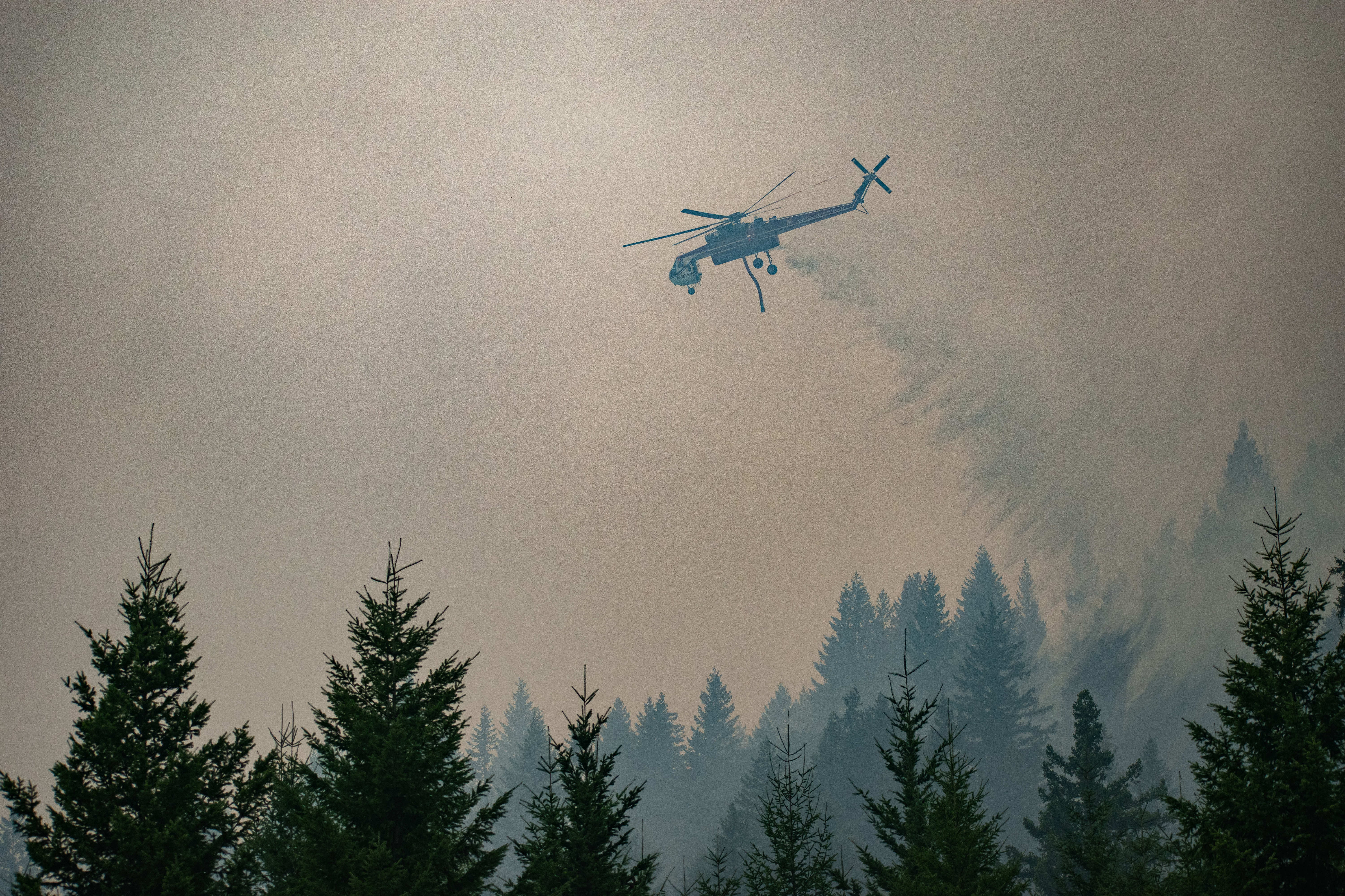 Helicopter dropping water on the Lookout Fire
