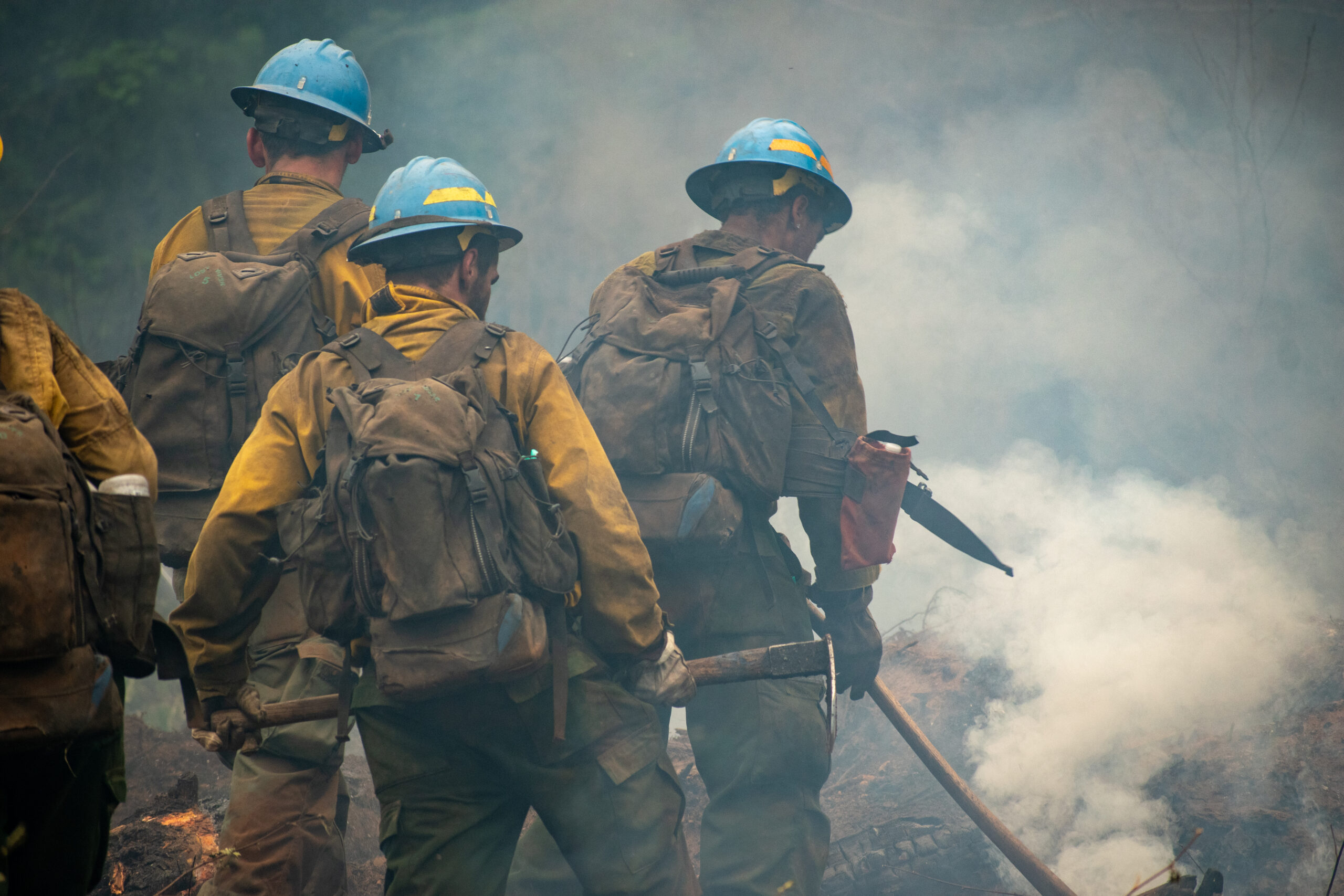 Firefighters walking as a group working at the Lookout Fire on August 18, 2023.