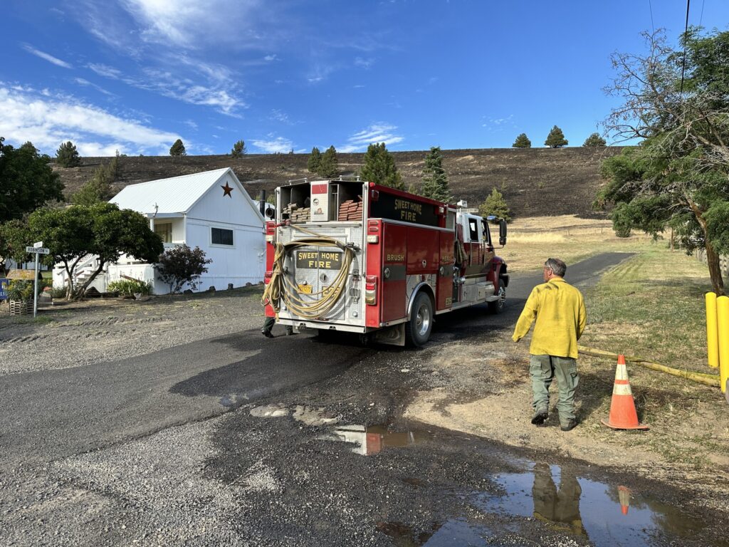 A fire engine and firefighter working at the Lone Rock Fire in Gilliam County.