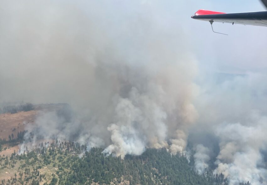 Lone Rock fire from the air. Smoke billowing into the air.