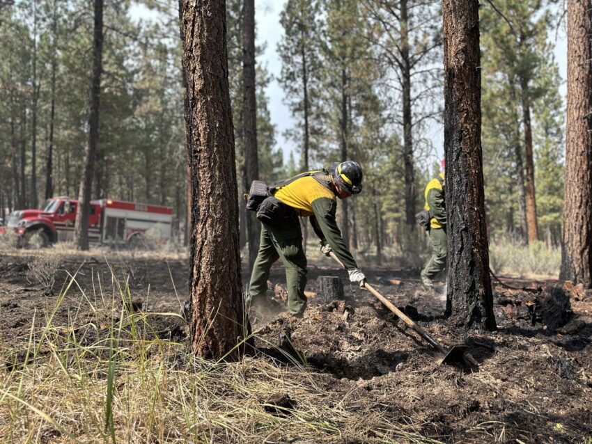 a firefighter putting out hot spots on the Copperfield Fire in Klamath County