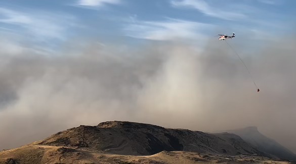 A helicopter flies over the Rowena Fire near The Dalles