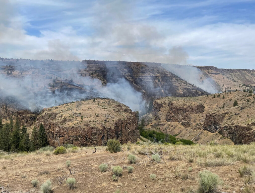 The Alder Springs Fire on June 16, 2025. A photo of a smoldering fire and smoke on the landscape.