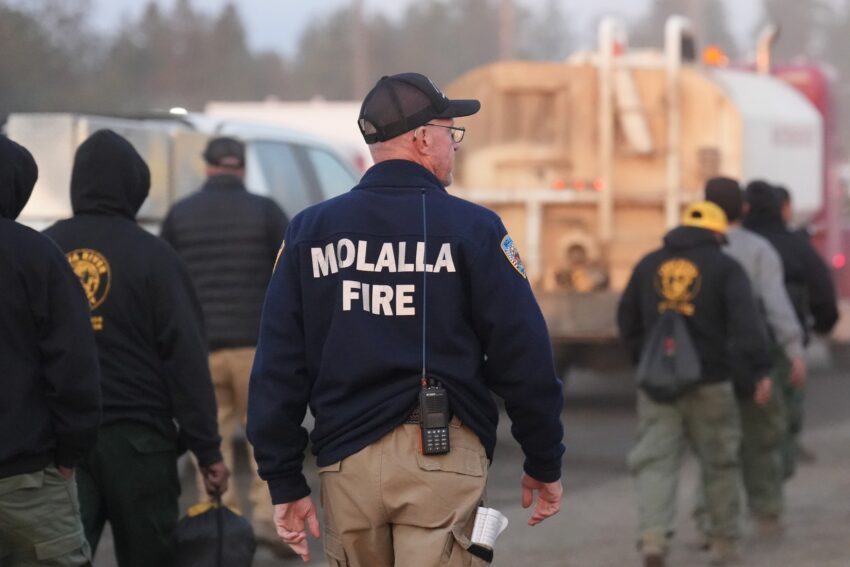 A person standing with Molalla Fire written on the back of their sweatshirt