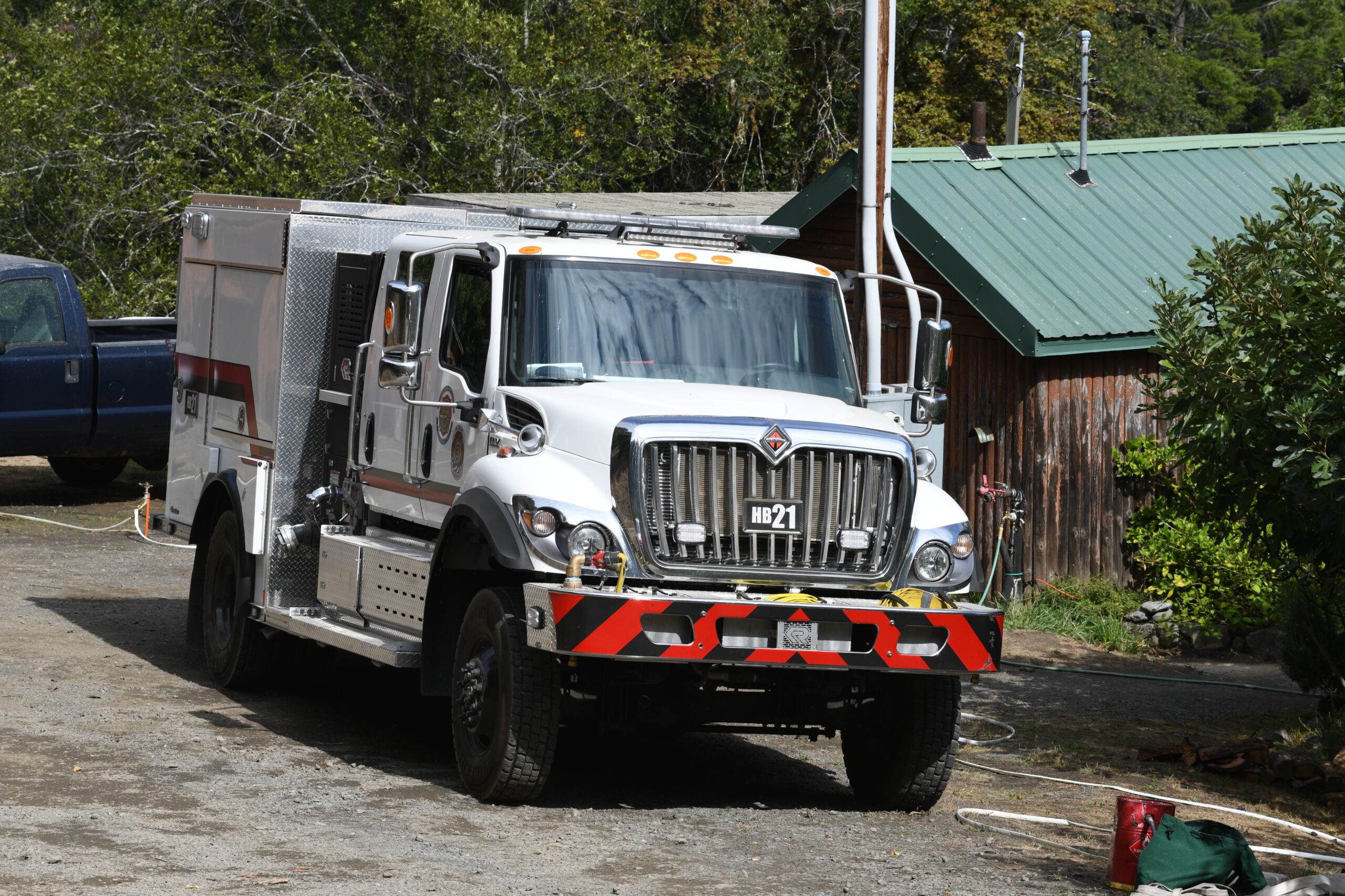 An OSFM Engine Program type 3 fire engine parked in front of a home on the Moon Complex